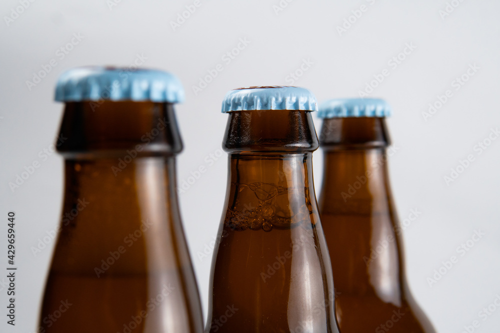 closed beer bottles on a white and black background