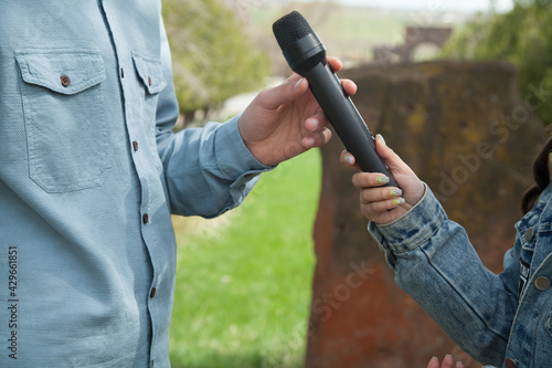 Journalist interrogates the man with a microphone.
