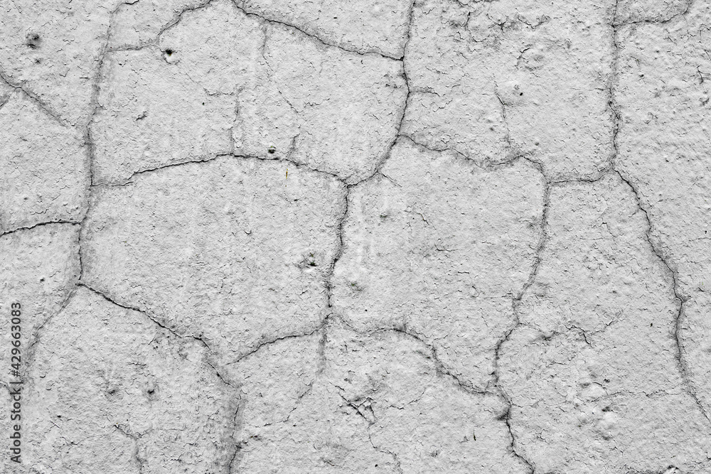 Texture of a concrete wall with cracks and scratches which can be used as a background Texture of a concrete wall with cracks and scratches which can be used as a background