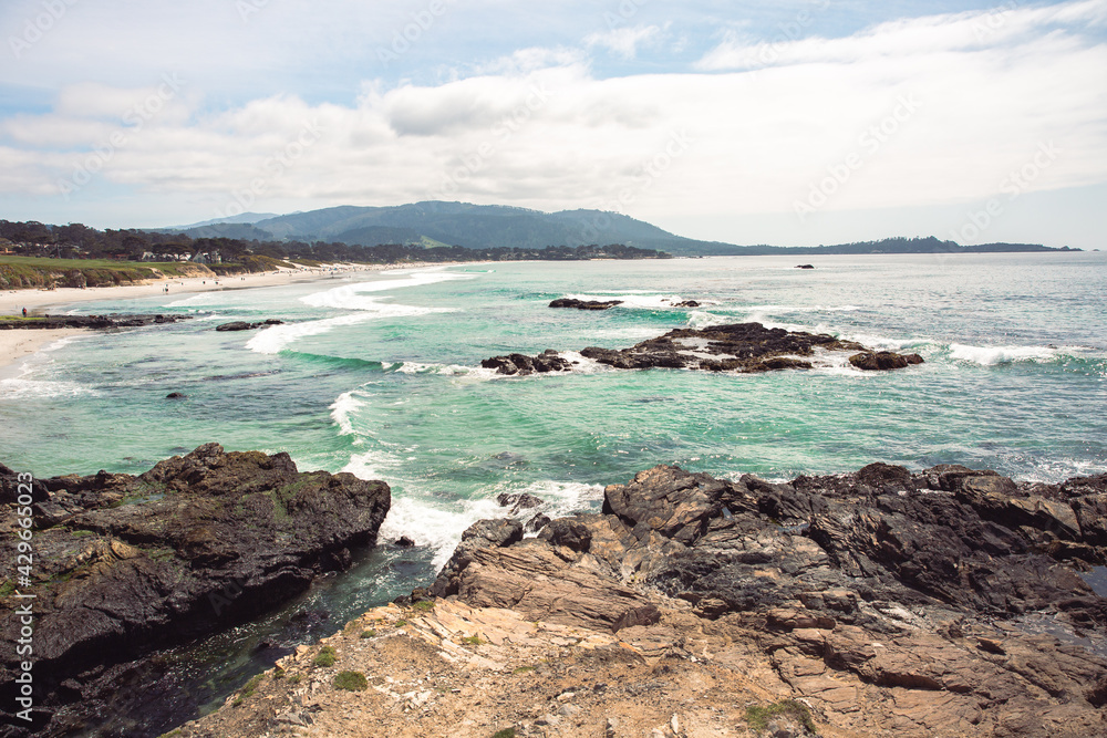 The Pacific Ocean coast in the city of Monterey in California. United States of America. Beautiful beach on a sunny day. Ocean landscape. The Pacific Ocean coast in the city of Monterey in California. United States of America. Beautiful beach on a sunny day. Ocean landscape.