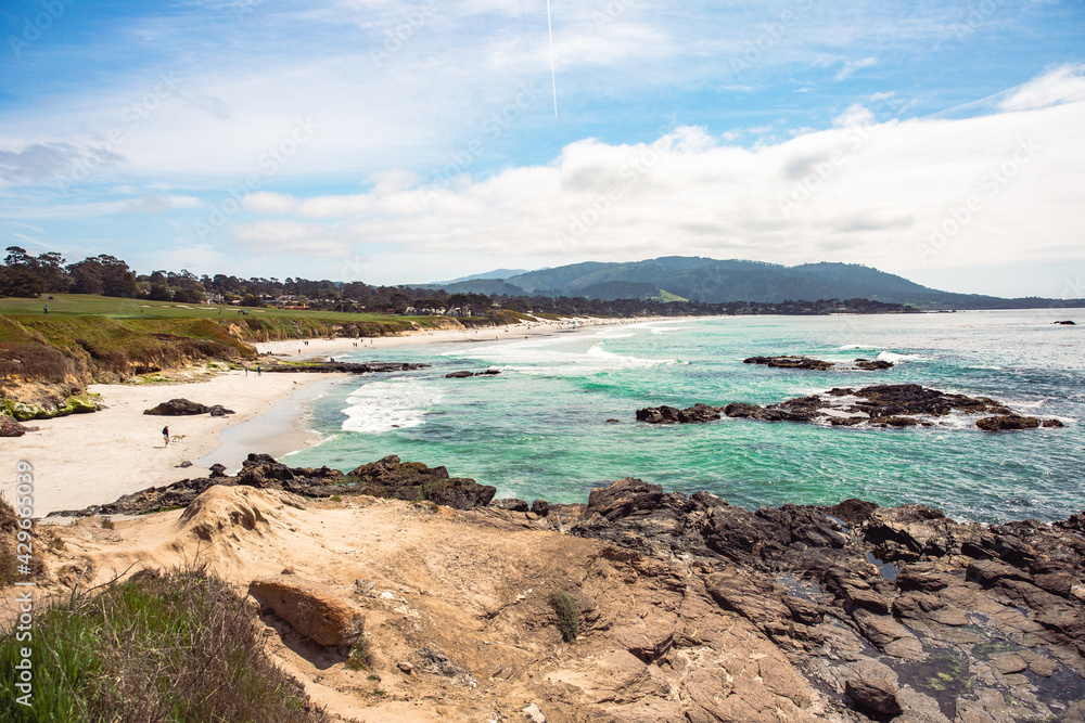 The Pacific Ocean coast in the city of Monterey in California. United States of America. Beautiful beach on a sunny day. Ocean landscape. The Pacific Ocean coast in the city of Monterey in California. United States of America. Beautiful beach on a sunny day. Ocean landscape.