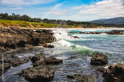 The Pacific Ocean coast in the city of Monterey in California. United States of America. Beautiful beach on a sunny day. Ocean landscape.