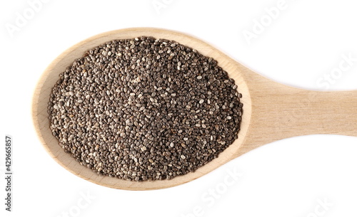 Chia seeds pile in wooden spoon isolated on white background, top view