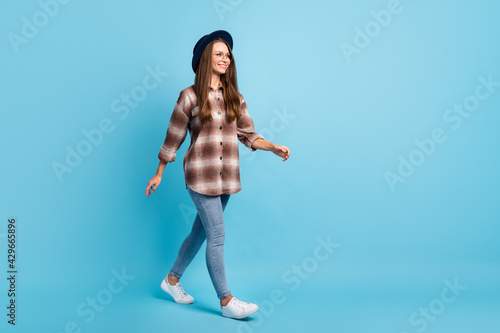 Fototapeta Naklejka Na Ścianę i Meble -  Full size profile side photo of young beautiful cheerful smiling woman look copyspace travel isolated on blue color background