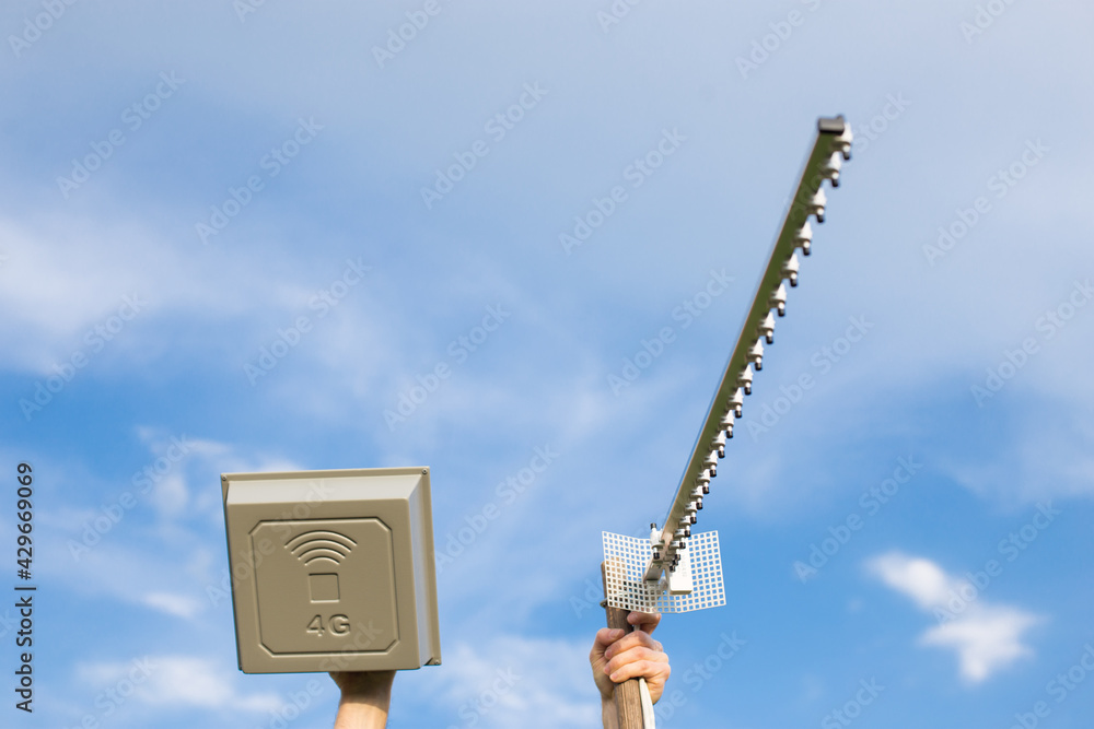 two different antennas in hands. Installing antennas for internet. two different antennas in hands. Installing antennas for internet.