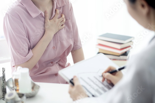 Doctor checking patient's chest pain