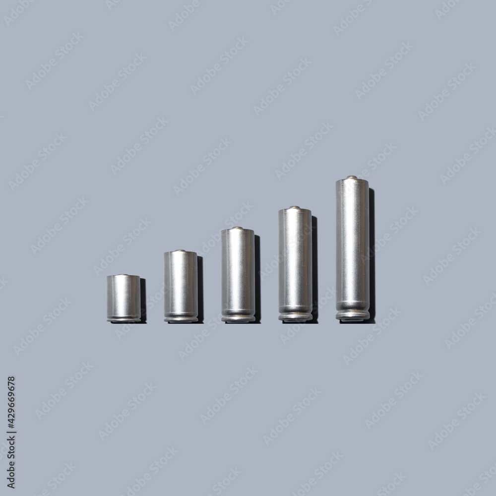Growing bar graph made from battery on grey background. Success, creative and start up concept. Growing bar graph made from battery on grey background. Success, creative and start up concept.