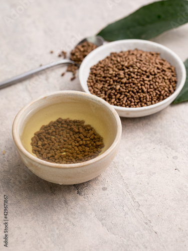 Top view of healthy soba tea and groats of tartary buckwheat Ku Qiao seeds on light background. Flat lay. Copy space