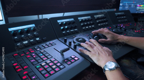Color grading control panel in post video production process. Telecine controller machine and man hand editing. Tools for colorist in film production. Color grading concept.