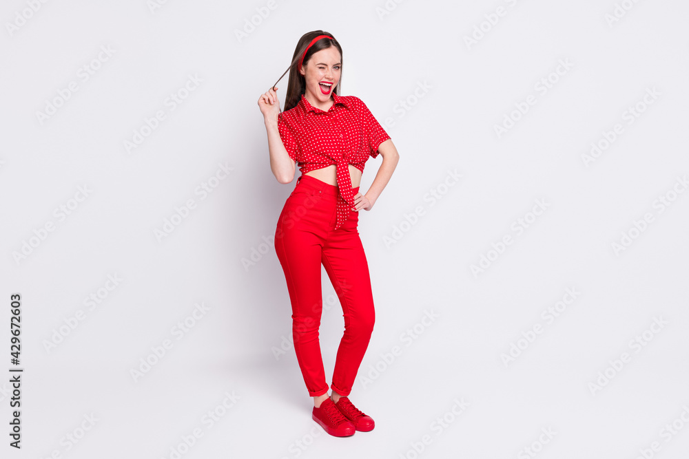 Photo of coquette funky girl play curl blink eye open mouth wear red dotted blouse pants sneakers isolated grey color background