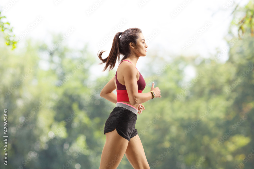 Fit young woman jogging in a park Fit young woman jogging in a park