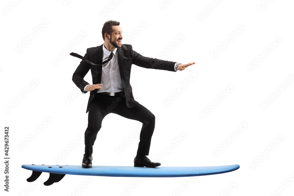 Full length profile shot of a businessman riding a surfboard - obrazy, fototapety, plakaty 