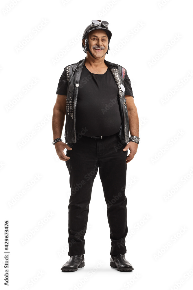 Full length portrait of a mature biker with a leather vest Full length portrait of a mature biker with a leather vest