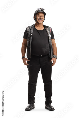 Full length portrait of a mature biker with a leather vest