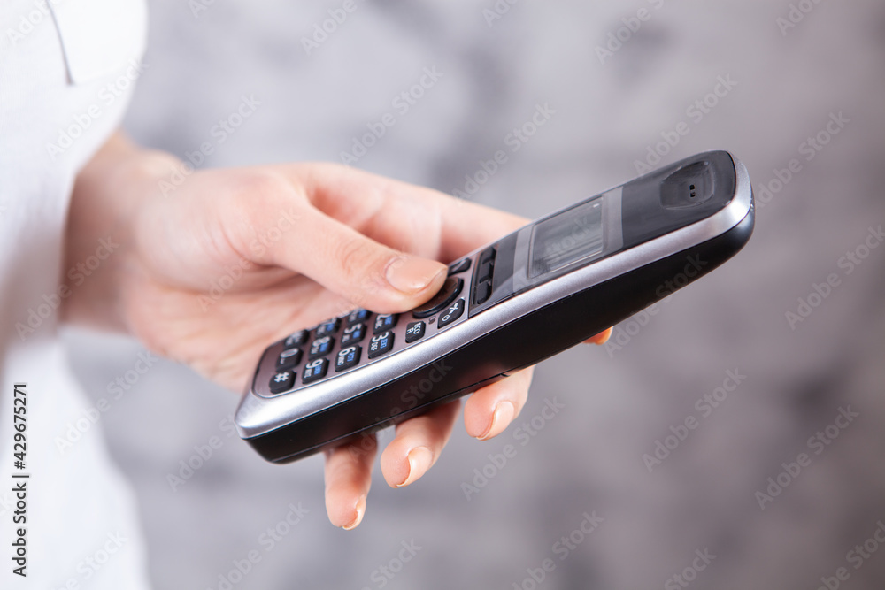 a young girl holding a phone in her hands a young girl holding a phone in her hands