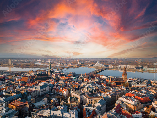 Aerial panorama view of old city Riga with beautiful sunset. Dome cathedral, bridges over River Daugava and National Librabry