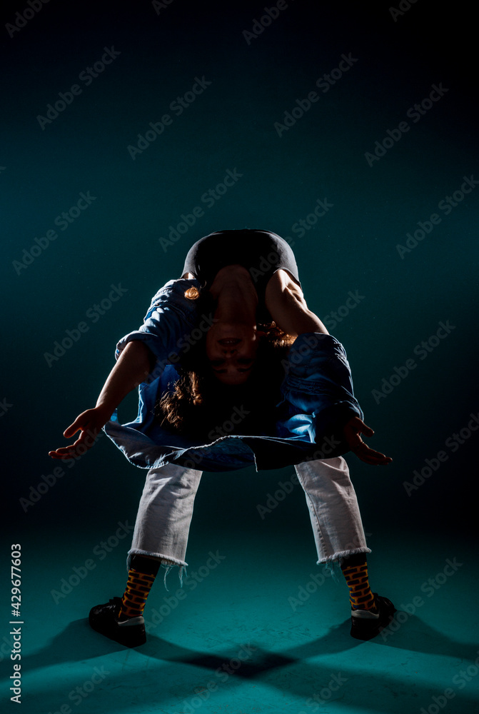 Stylish contemporary dance isolated on dark cyan background