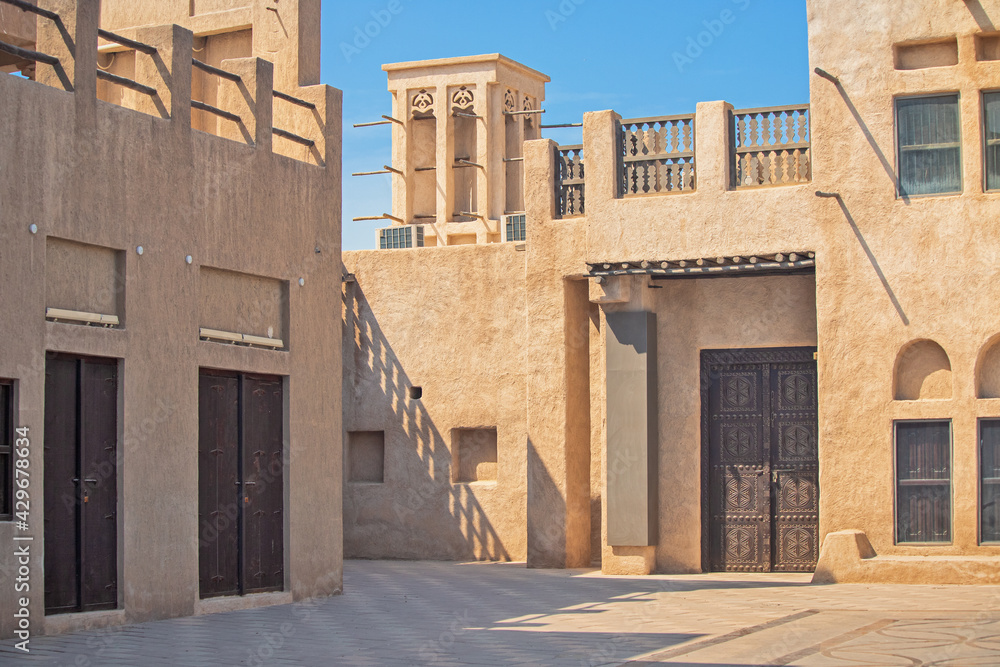Narrow streets that create shade on a hot day in the old city of Dubai Creek and Bur district. Travel destinations and heritage village