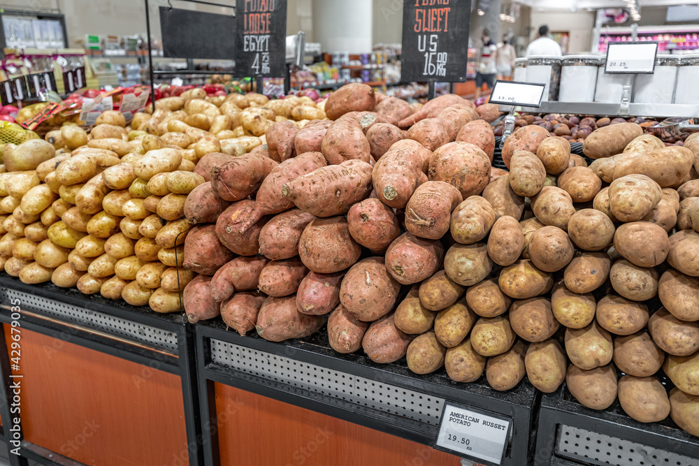 American sort of Russet potatoes on supermarket shelves for sale. Farm crop and vegetable concept with gluten and starch