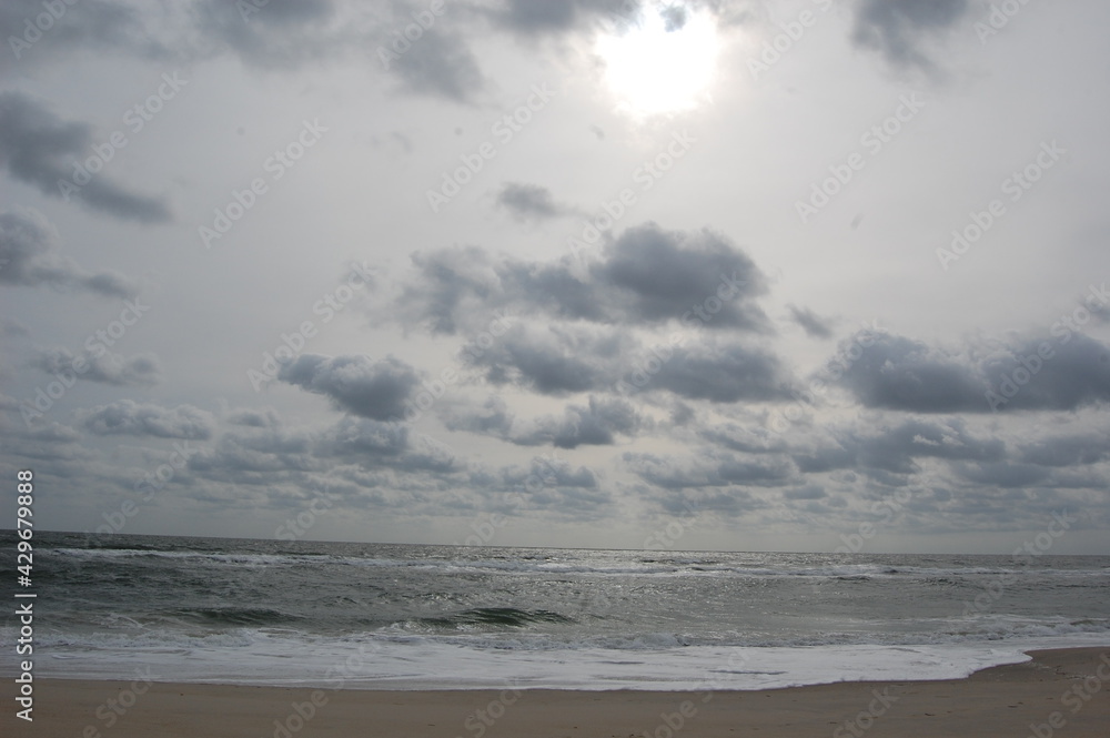 Rays of sunshine breaking through the clouds, casting light on the Atlantic Ocean, Assateague Island, Maryland. Rays of sunshine breaking through the clouds, casting light on the Atlantic Ocean, Assateague Island, Maryland.