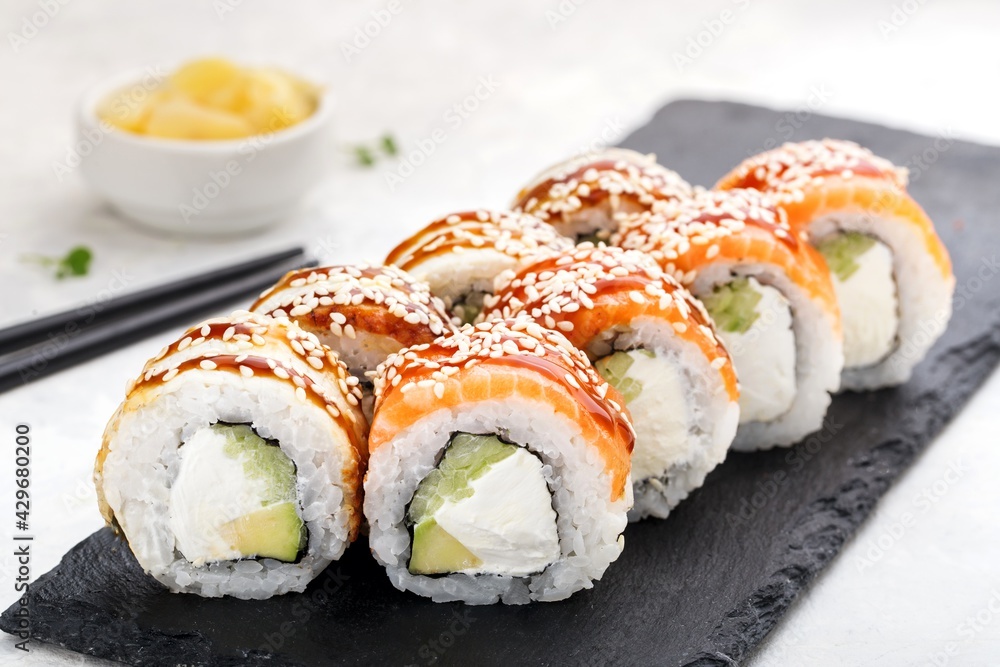 Sushi roll set with salmon,ell, avocado, cucumber,cream cheese, sesame and sauce. Sushi menu. Japanese food. Sushi roll set with salmon,ell, avocado, cucumber,cream cheese, sesame and sauce. Sushi menu. Japanese food.
