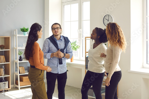 Tableau sur toile Intelligent young diverse business people or coworkers communicating, discussing work and exchanging opinions in informal office meeting