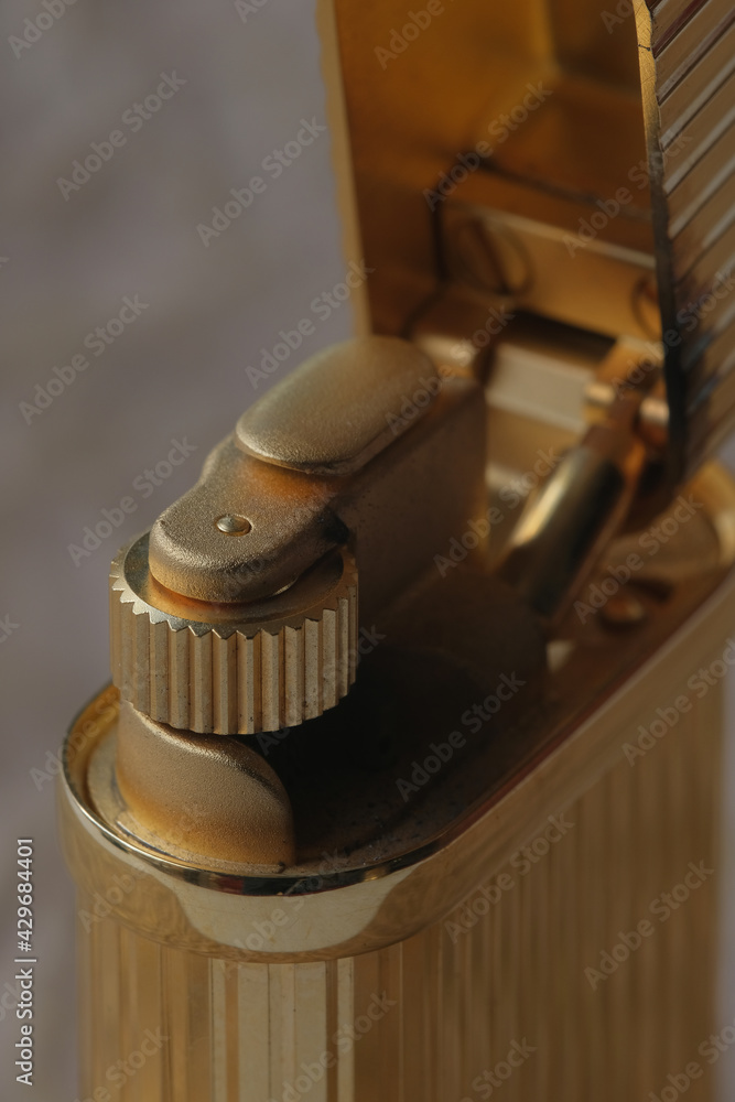 Macro shot of a lighter, parts devices, wheels for extracting sparks and holes in places of fire. Close-up. View from above. High quality photo Macro shot of a lighter, parts devices, wheels for extracting sparks and holes in places of fire. Close-up. View from above. High quality photo
