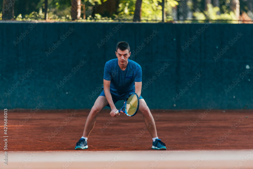 Focused male athlete waiting to receive the ball in a professional tennis game