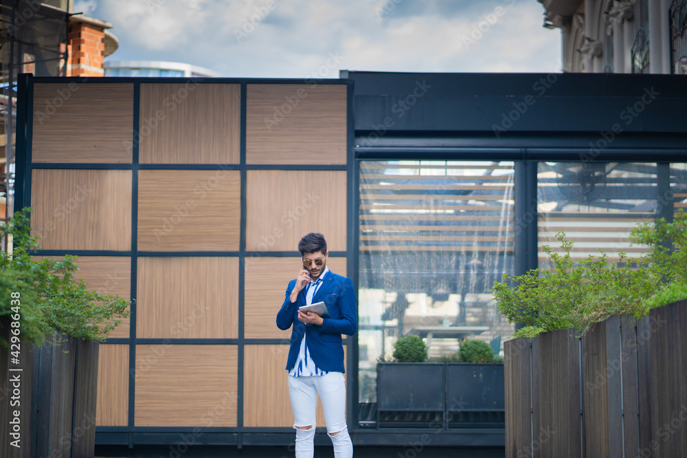 Urban businessman is talking in front of his company Urban businessman is talking in front of his company