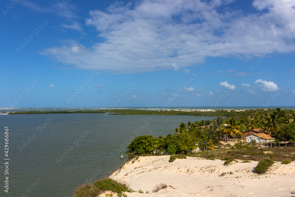 Vegetation and sand dunes of the dry mangrove (Dunas do Mangue Seco) in Bahia providing a beautiful view of the blue sea.