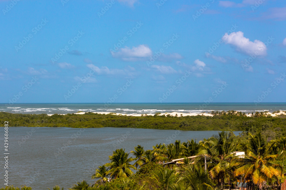 Vegetation and sand dunes of the dry mangrove (Dunas do Mangue Seco) in Bahia providing a beautiful view of the blue sea. A famous place of recording of the soap opera Tieta.