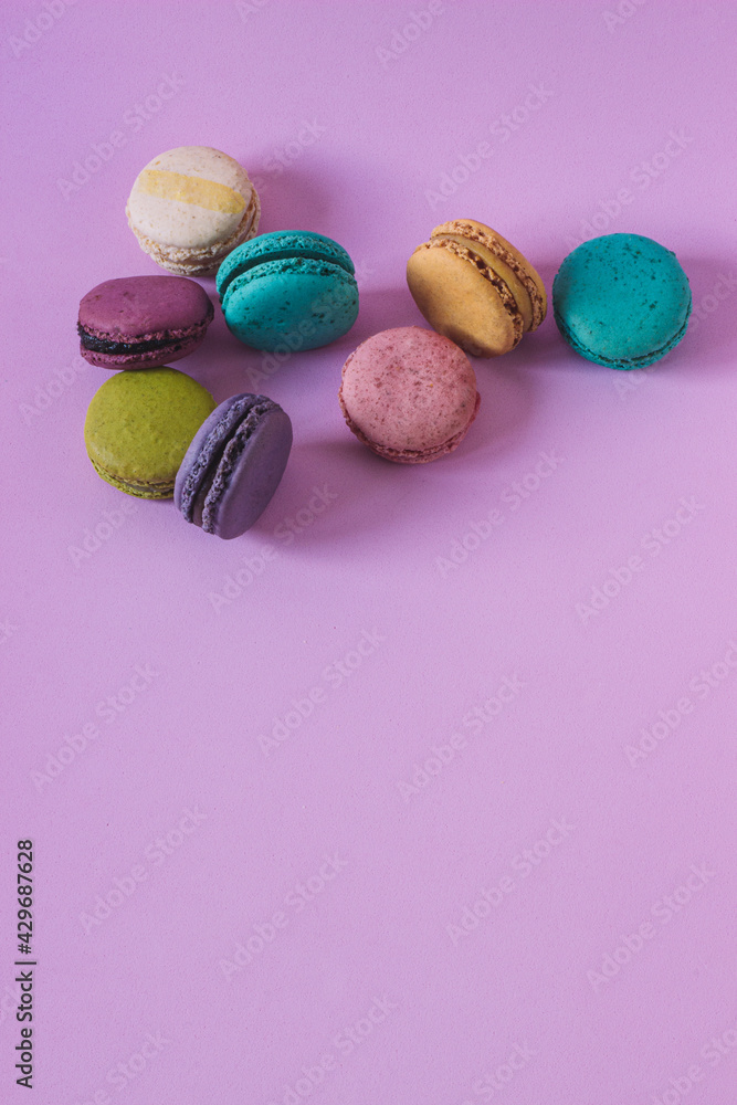 Vertical shot of colorful macaroons on a pink background. Vertical shot of colorful macaroons on a pink background.