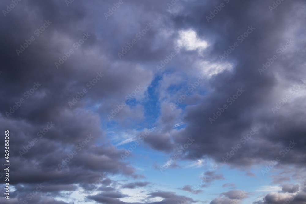 Blue sky behind dark storm clouds background texture, thunderstorm
Blue sky behind dark storm clouds background texture, thunderstorm