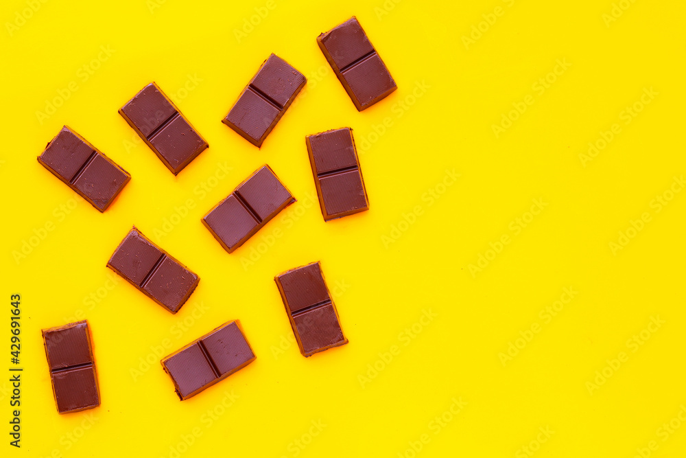 Chocolate bar isolated on yellow background Chocolate bar isolated on yellow background