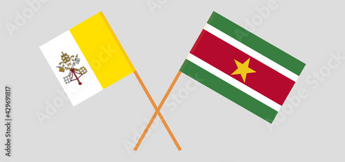 Crossed flags of Vatican and Suriname. Official colors. Correct proportion