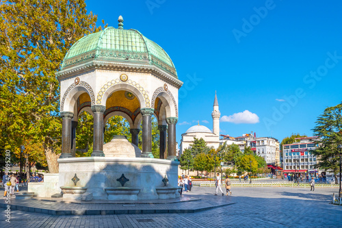 Photography Tourists pass by the German Fountain, a gazebo styled fountain in Sultanahmet Sq