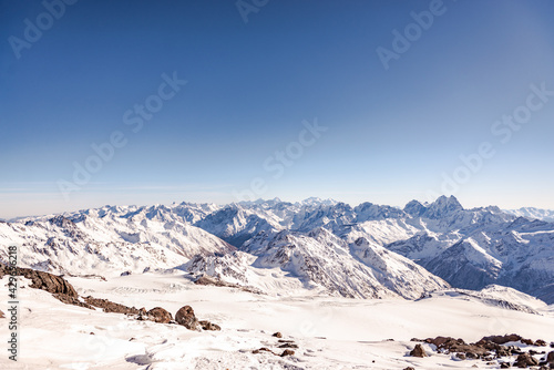 Panorama of the mountains from Elbrus. The peaks of the Caucasus mountains under your feet. White mountain peaks.
