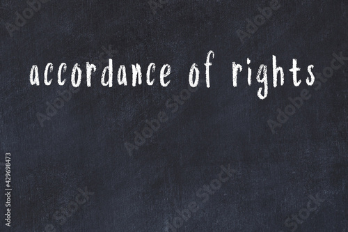 College chalk desk with the word accordance of rights written on in photo