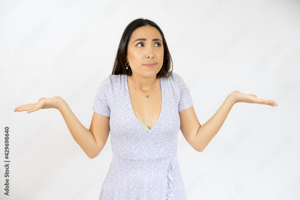 Young hispanic woman wearing casual clothes clueless and confused with open arms, no idea and doubtful face. Young hispanic woman wearing casual clothes clueless and confused with open arms, no idea and doubtful face.