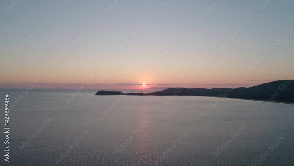 Aerial lanscape of sea and sun refclections on the water surface. Pink sunset on an autumn day. Aerial lanscape of sea and sun refclections on the water surface. Pink sunset on an autumn day.