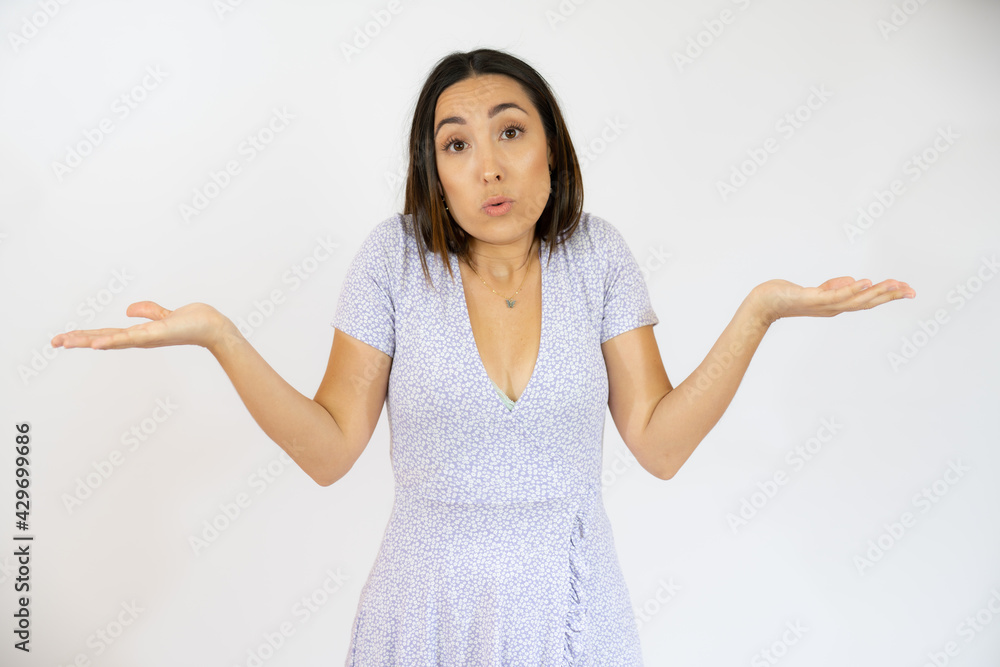 Young hispanic woman wearing casual clothes clueless and confused with open arms, no idea and doubtful face. Young hispanic woman wearing casual clothes clueless and confused with open arms, no idea and doubtful face.