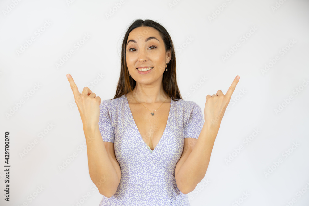 Portrait of beautiful young woman pointing up over white background. Portrait of beautiful young woman pointing up over white background.