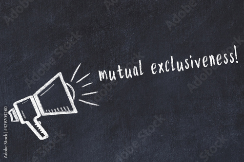 Photos Chalk loudspeaker and inscription mutual exclusiveness on black chalkboard