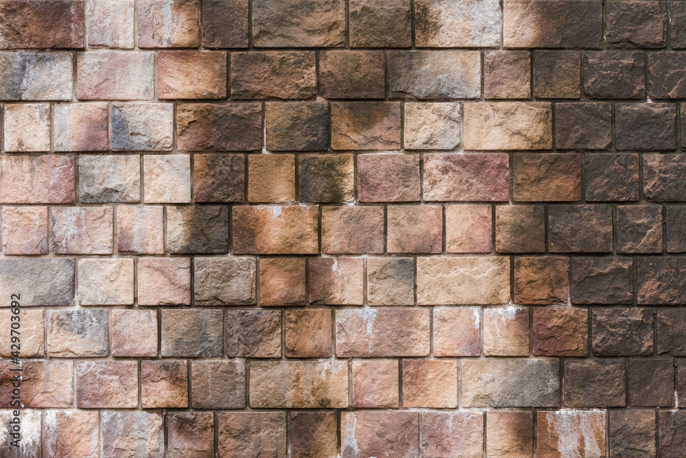 Wet colorful brick wall background texture.
