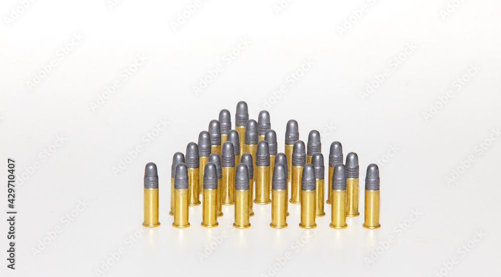 Ammunition and cartridges of caliber .22 with leaded tip of firearm placed on clear surface Ammunition and cartridges of caliber .22 with leaded tip of firearm placed on clear surface