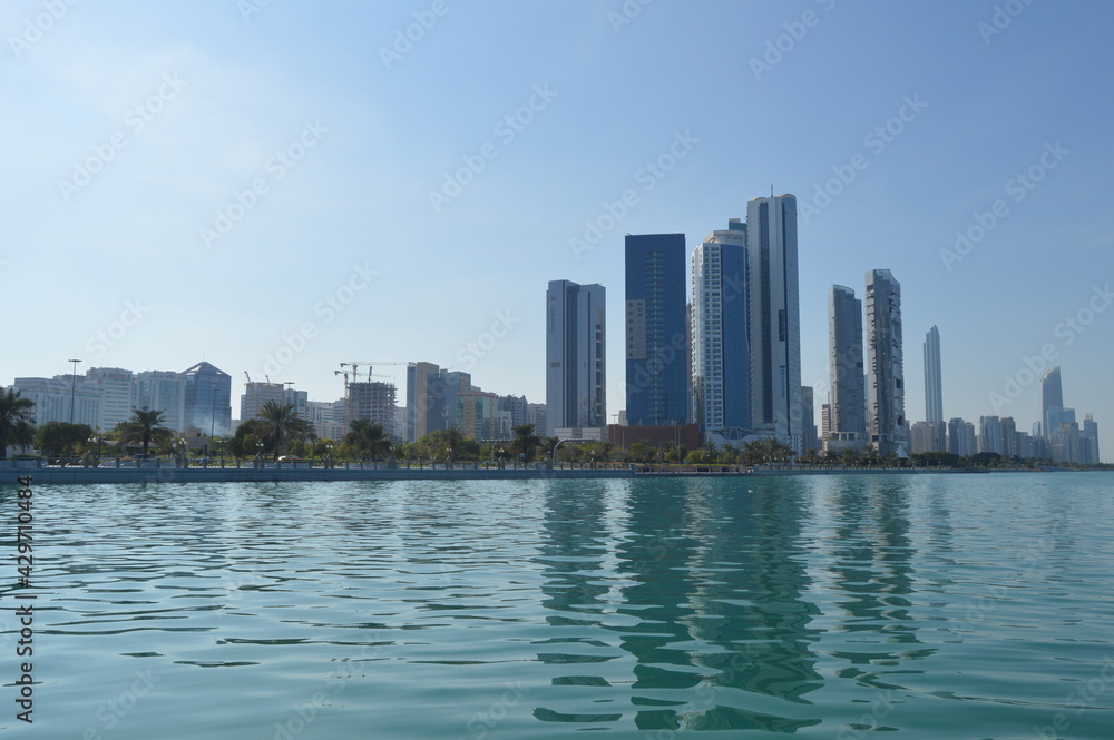 Fototapeta premium Abu Dhabi city skyline along Corniche beach taken from a boat