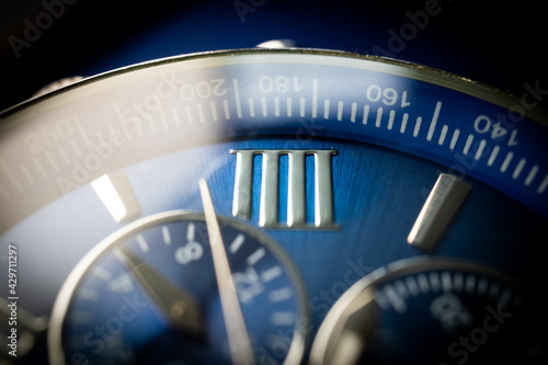 Fotografie Macro Close Up of Roman Numeral Four on Blue Faced Chronograph Watch