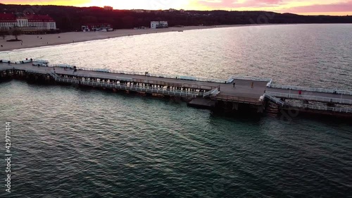 Cinematic pier in the sunset from a bird's eye view. Filming at sunset in Sopot.