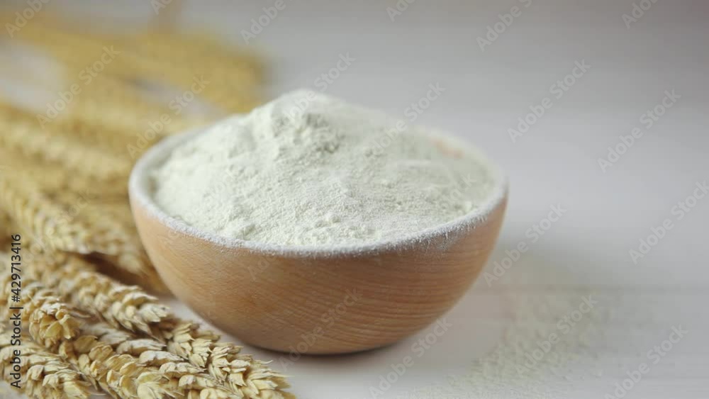 Wheat flour, wheat grains and spikelets on a wooden table. Sift flour. Wheat flour, wheat grains and spikelets on a wooden table. Sift flour.