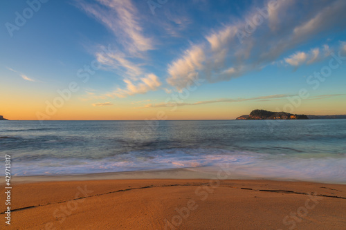 Sunrise seascape with scattered high cloud